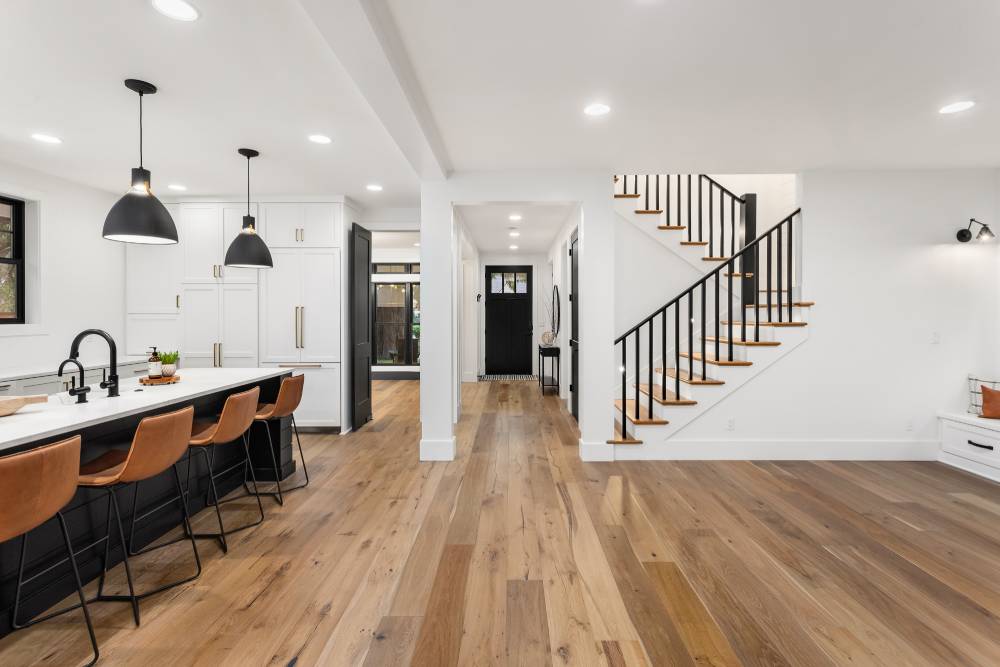 An open floor plan kitchen with hardwood floors.